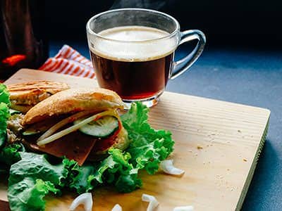 Toasted sandwich with salad and a glass of coffee