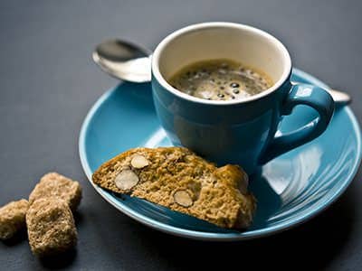 Espresso in a blue cup with almond biscotti