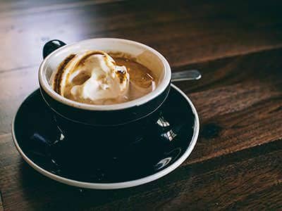 Affogato with a scoop of ice cream in a dark cup