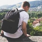 Traveller with a backpack above a town