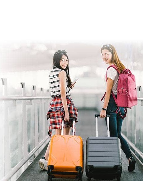 Two travellers pulling cabin trolleys on a pier