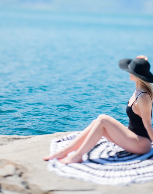 Woman in a black swimsuit on the shore