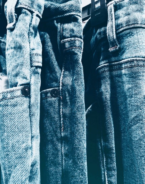 Blue jeans hanging on a rail