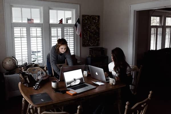 Two colleagues working at a shared desk