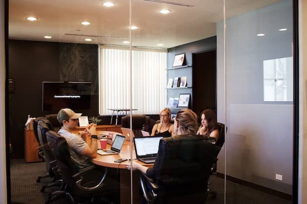 A meeting in a glass-walled boardroom