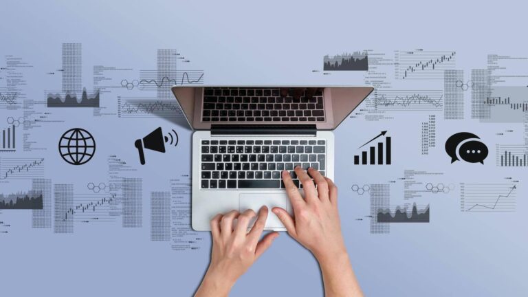 Hands on a laptop keyboard surrounded by charts, figures and data icons