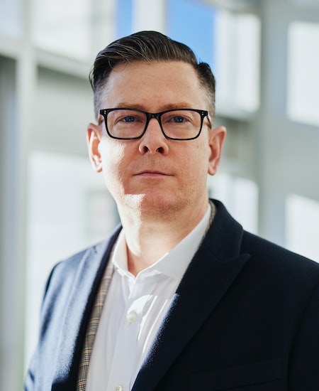 Portrait of an adviser in a dark jacket and glasses