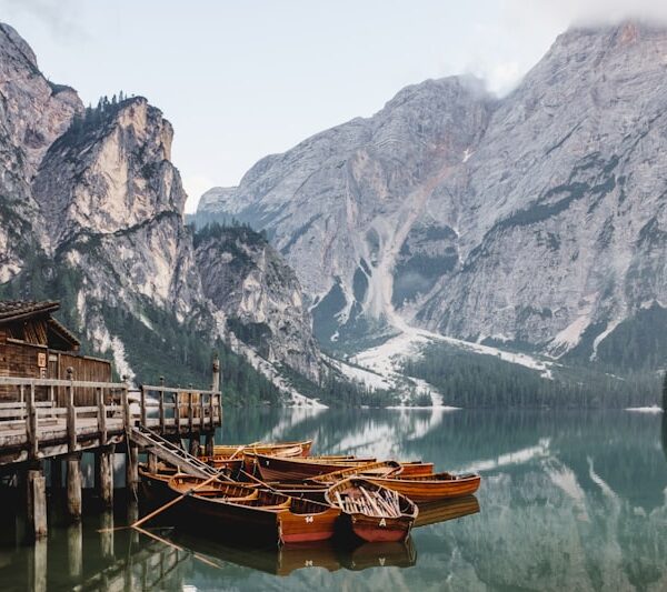 Wooden boats moored on an alpine lake at first light
