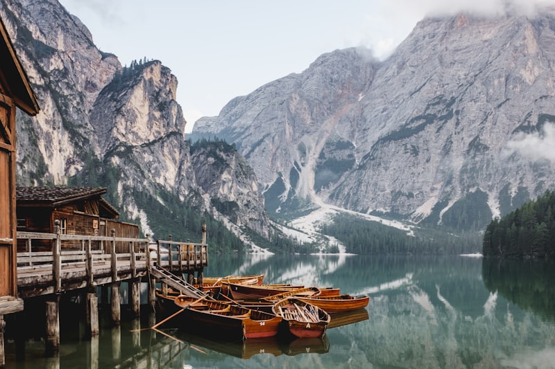Wooden boats moored on an alpine lake at first light