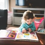 A toddler turning the pages of a picture book