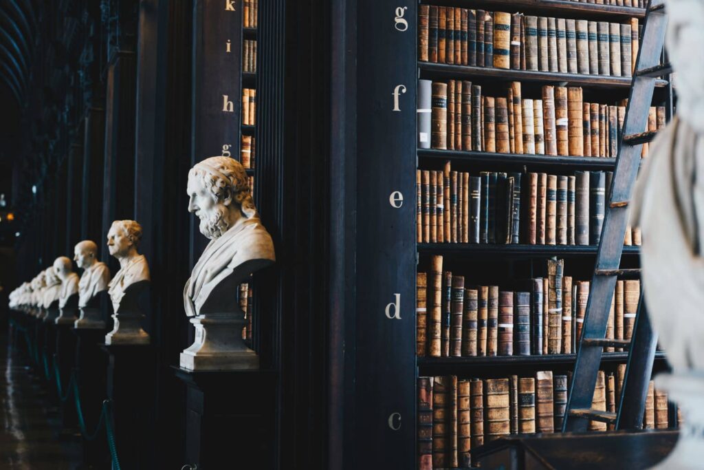 Historic law library with leather-bound volumes and marble busts