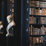 Historic law library with leather-bound volumes and marble busts
