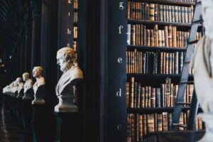 Historic law library with leather-bound volumes and marble busts