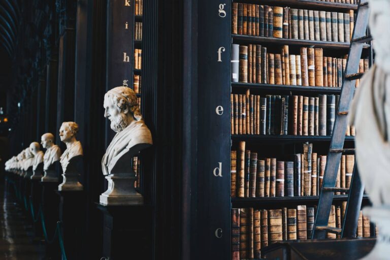 Historic law library with leather-bound volumes and marble busts