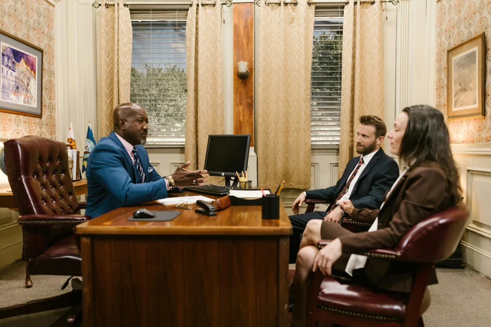 A mortgage advisor meeting a couple across an office desk