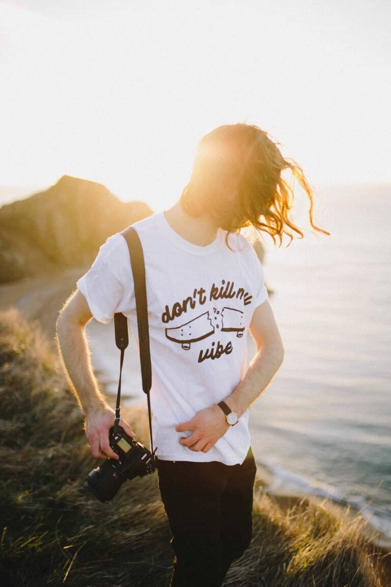 Portrait of a woman on a hilltop with wind in her hair at sunset