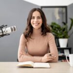 Host at the studio microphone with her notes