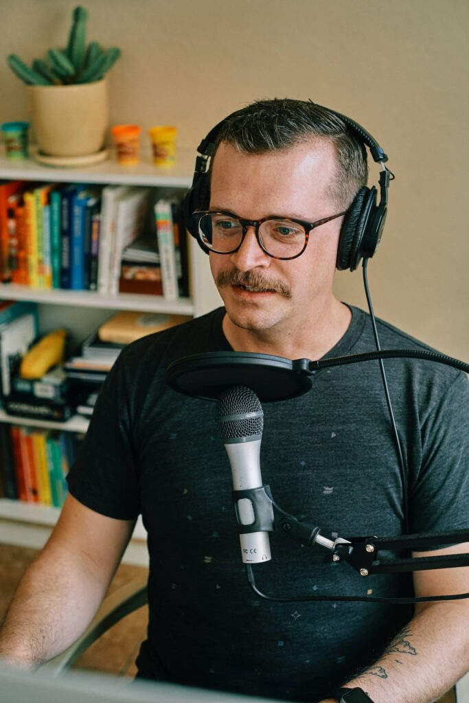Guest wearing headphones at the studio microphone