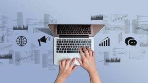 Hands at a laptop surrounded by media icons