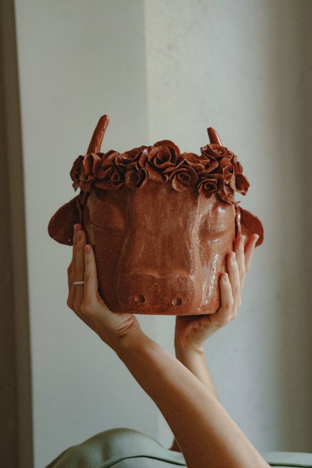 Light brown goat jar in a studio setting